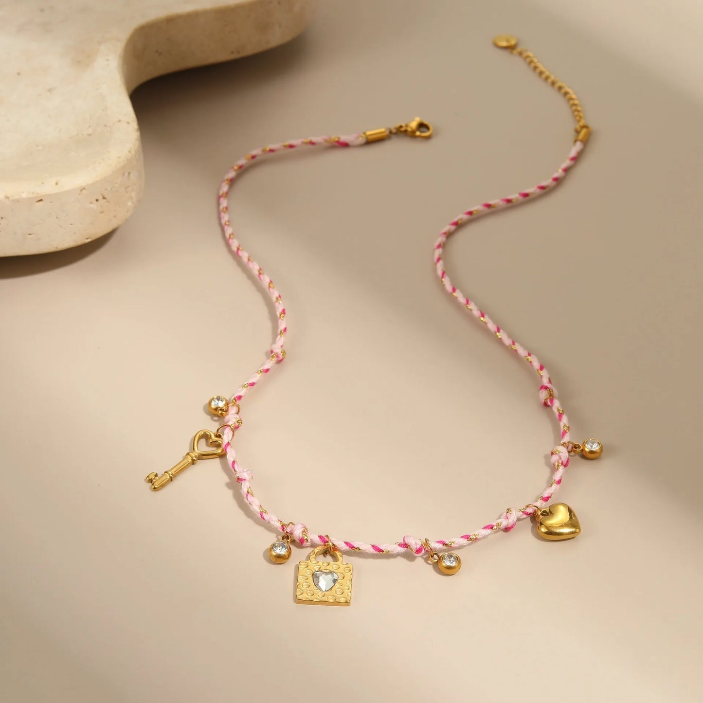 Handmade braided rope titanium steel necklace and bracelet with heart pendant on 18K gold plated chain.