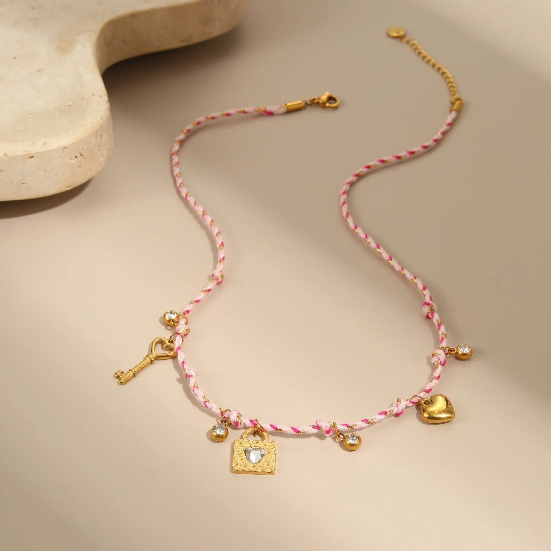 Handmade braided rope titanium steel necklace and bracelet with heart pendant on 18K gold plated chain.