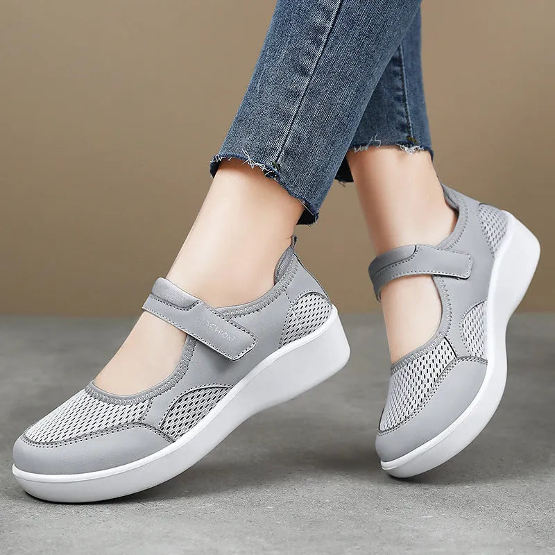 Women's grey velcro casual shoes with mesh upper and flat sole.