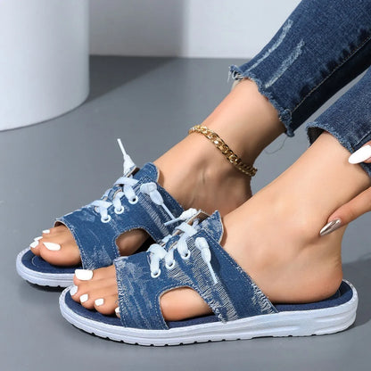 Blue Roman-style women's flat canvas slippers with a cloth upper and rubber sole.