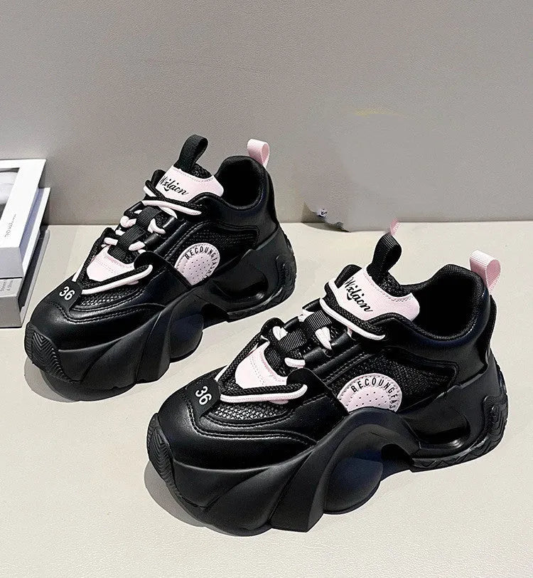 Women's pink sneakers with cross straps, thick sole, and mesh lining on a white background
