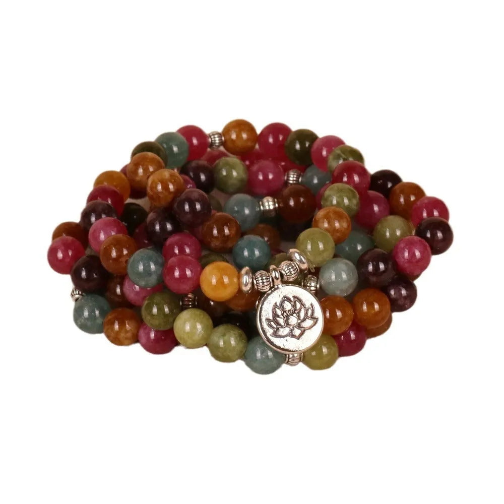 Close-up of a multi-layer beaded bracelet with 108 tourmaline beads and alloy string, showing lotus hanging detail.