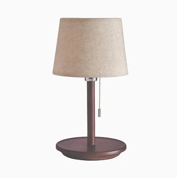 Walnut solid wood bedside lamp with fabric lampshade on wooden surface