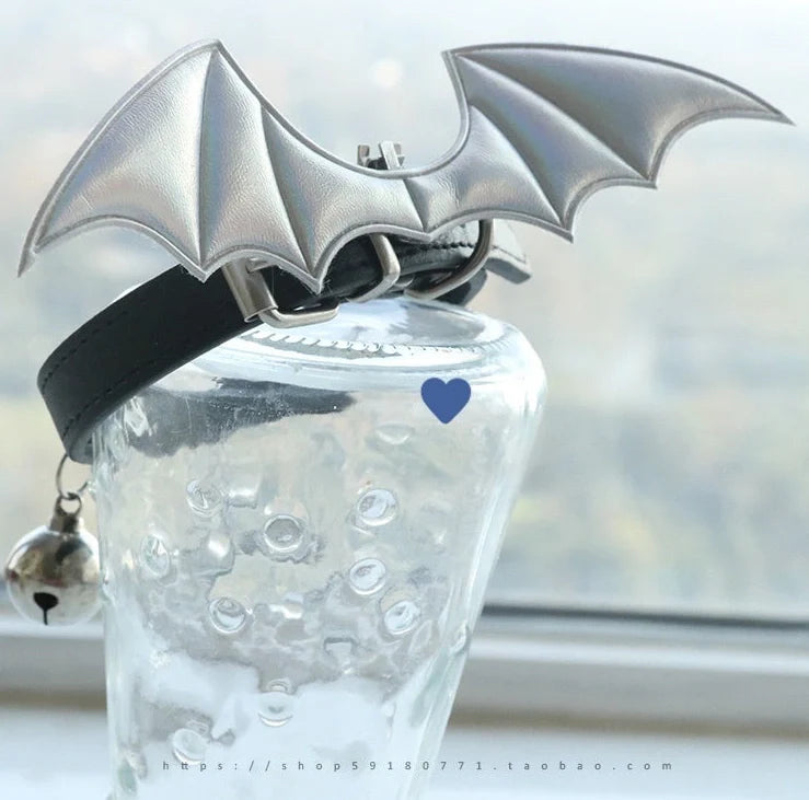 Black patent leather choker with 15cm wings decoration and bell attachment on adjustable 30-40cm collar