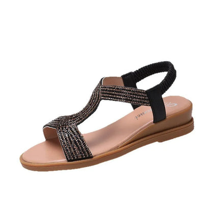 Gold patent leather women's sandals with rhinestone decoration on the strap.