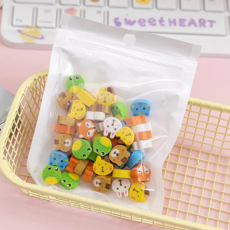 Assortment of 50 small cartoon erasers in pearlescent bags, showing fruit, animal, and holiday designs.