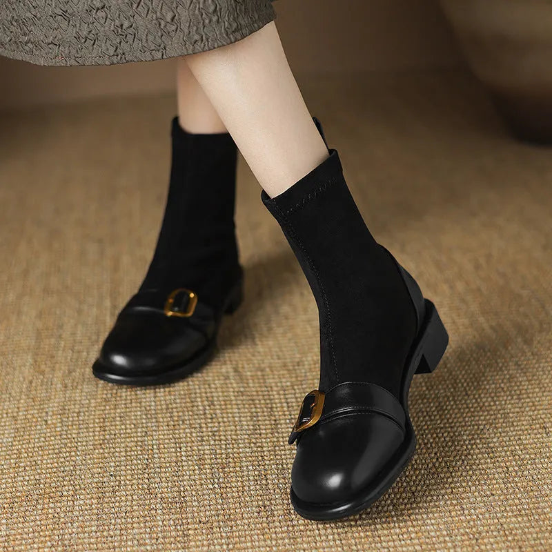 Women's black casual Martin boots with low heel, lace-up front, and decorative belt buckle stitching.