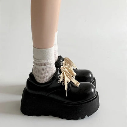 Women's black matte lace-up shoes with 6-8cm English muffin heel and round toe, shown on a neutral background