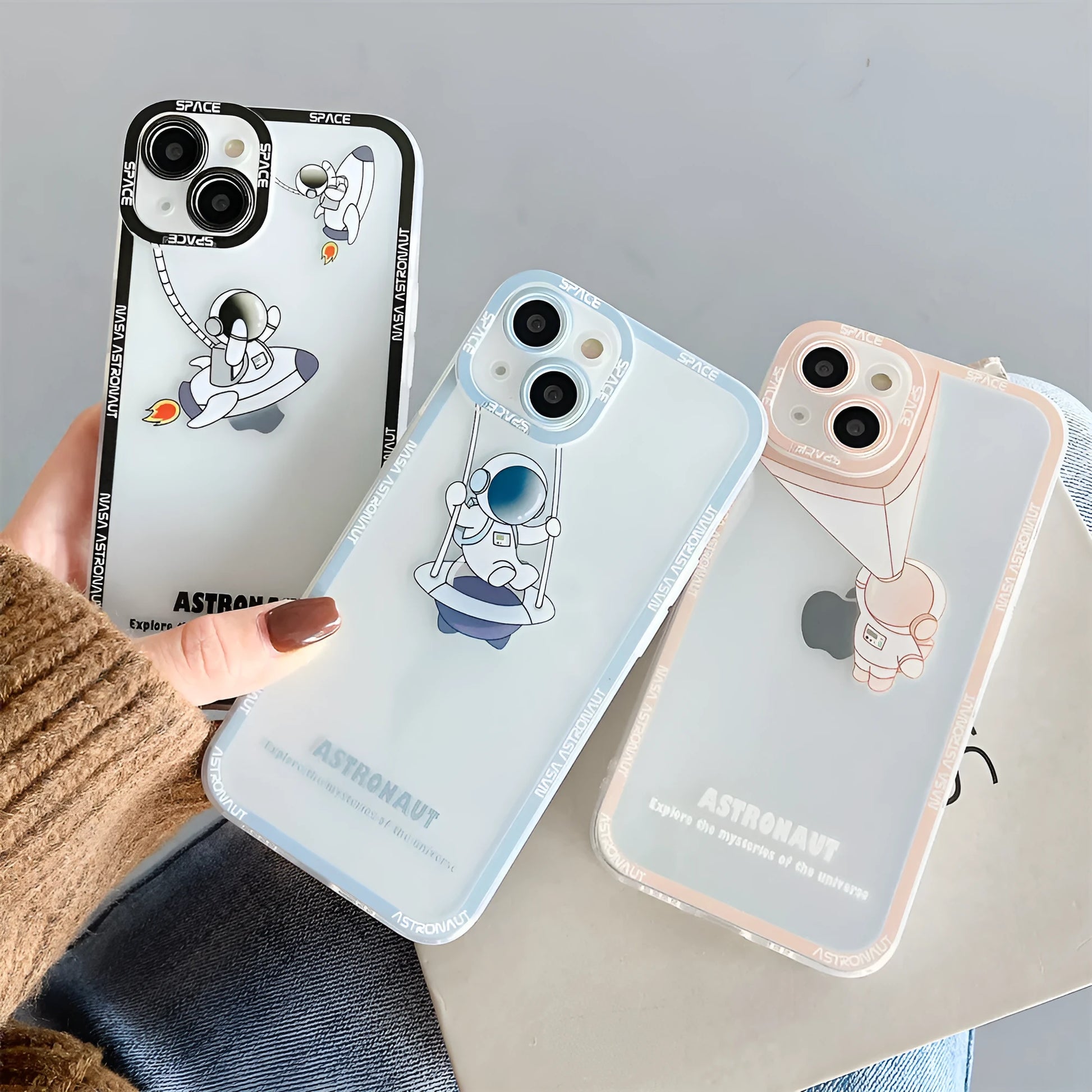 Transparent silicone iPhone case with blue astronaut print, shown on a phone.
