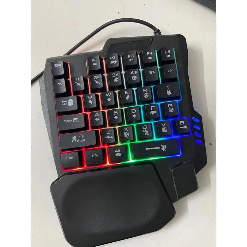 Black one-handed mechanical keyboard and mouse set with a 1.5 metre USB cable on a desktop.