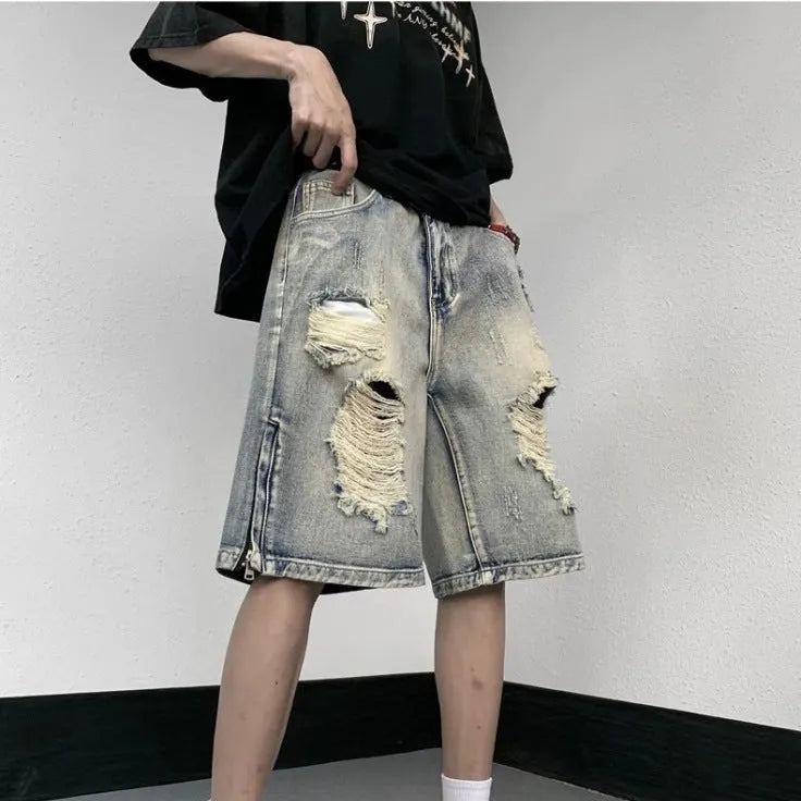 Blue denim shorts with wide-leg cut and tattered retro detailing on mannequin