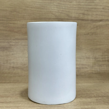 American-style solid resin tissue box holder in a funny design, measuring 8.5 by 14.6 centimetres, on a wooden desk.