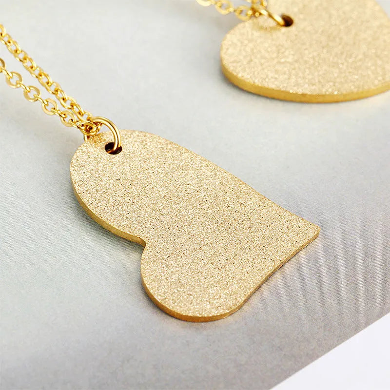 Women's titanium steel necklace with a simple geometric heart-shaped pendant.