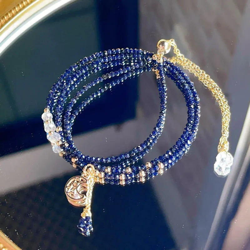 Blue gold sand stone cut three-ring multi-layer bracelet for women on a wrist.