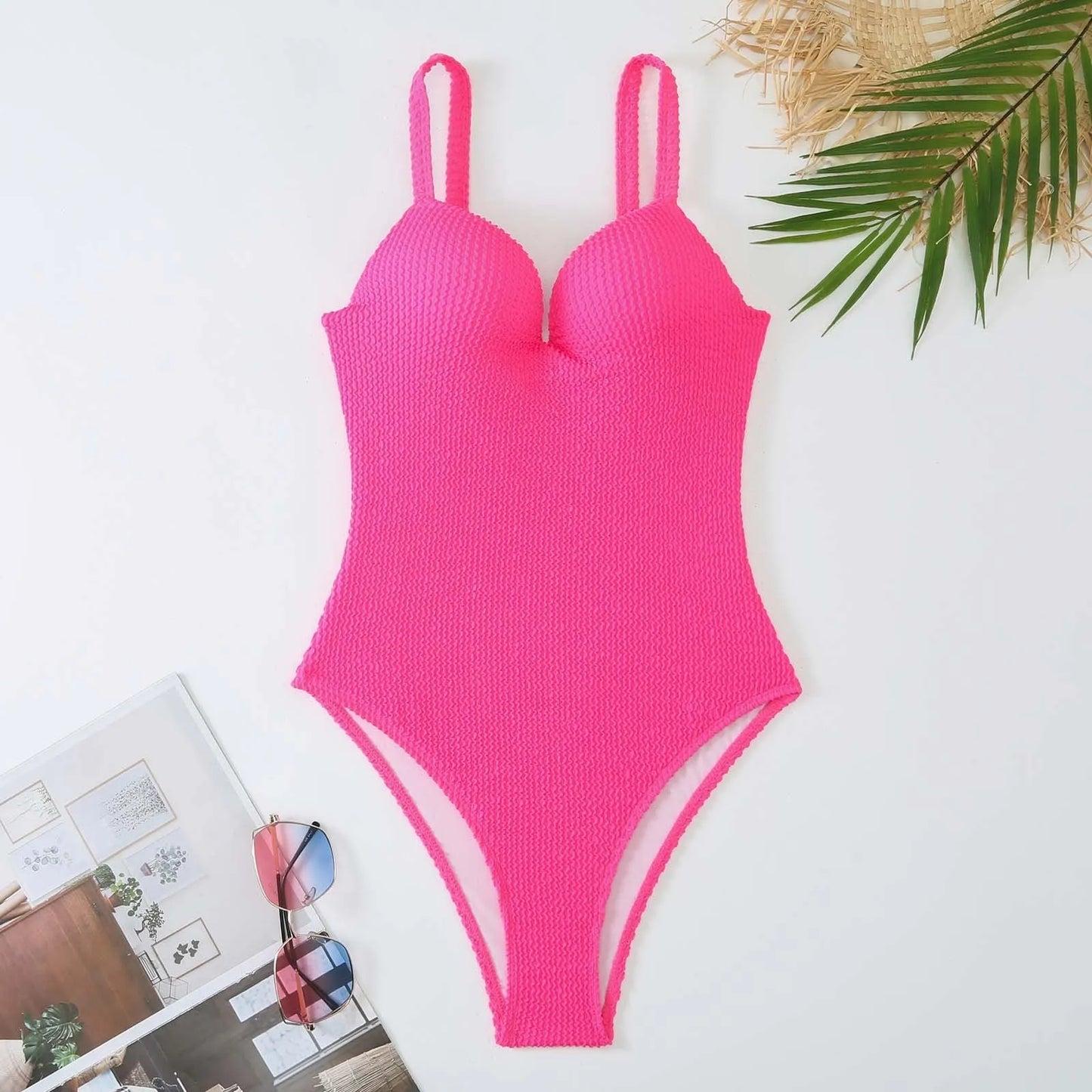 Women's black one-piece swimsuit with a sunken vertical stripe detail, shown on a model, featuring a sleeveless design.
