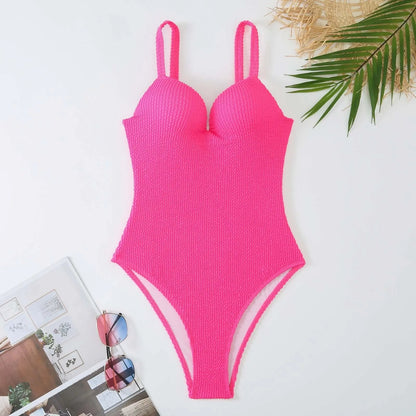 Women's black one-piece swimsuit with a sunken vertical stripe detail, shown on a model, featuring a sleeveless design.