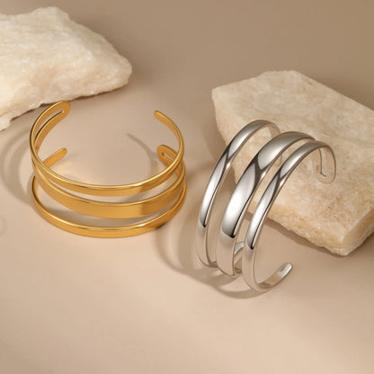 Women's stainless steel bracelet with geometric line design and simple opening clasp in gold electroplated finish