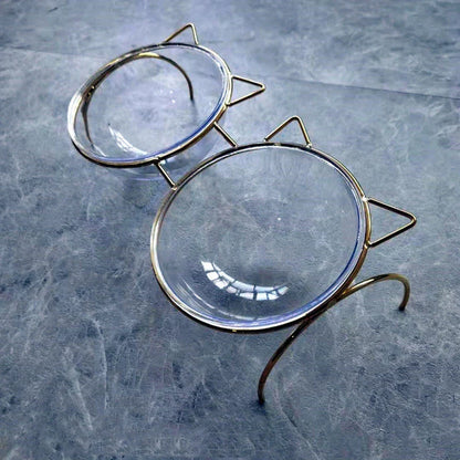 Elegant glass cat bowl with raised metal stand for pets, featuring a shimmering glass bowl and sturdy metal frame to support your cat's hydration and posture.
