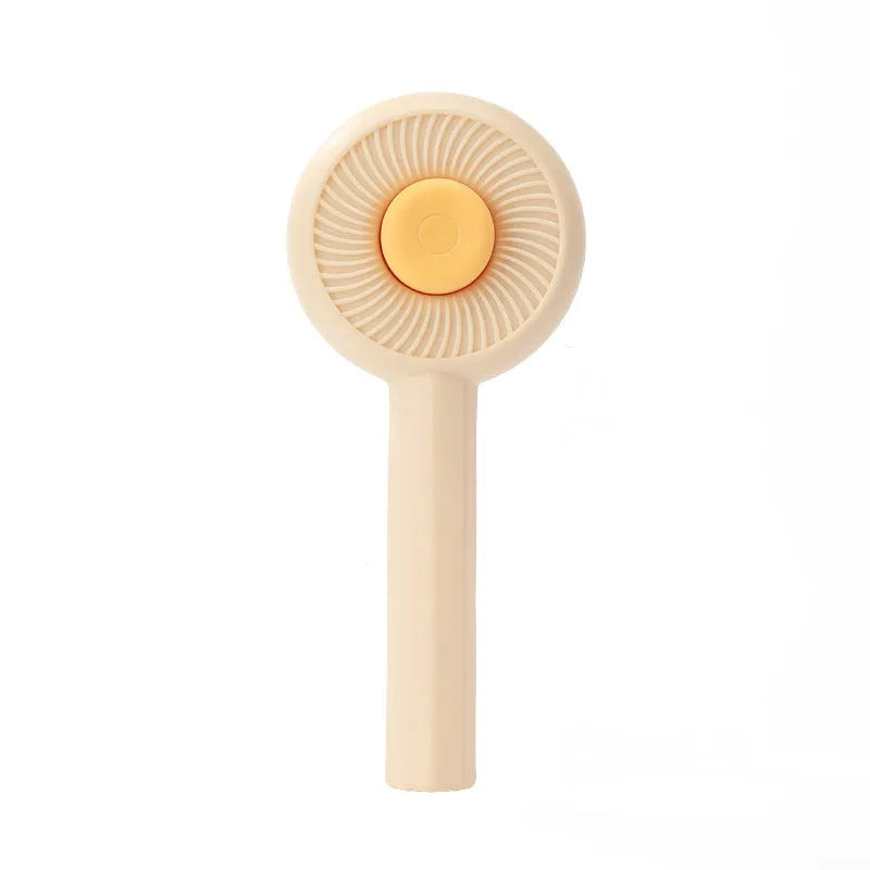 Blue and yellow self-cleaning pet grooming brush with angled metal needles and a push-button on the handle.