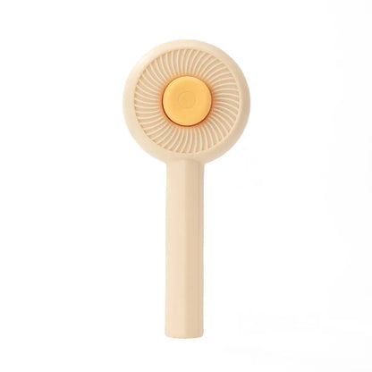Blue and yellow self-cleaning pet grooming brush with angled metal needles and a push-button on the handle.