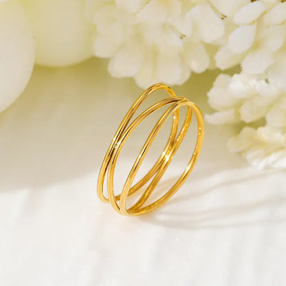 Geometric line ring with three-layer gold coil design on titanium steel band