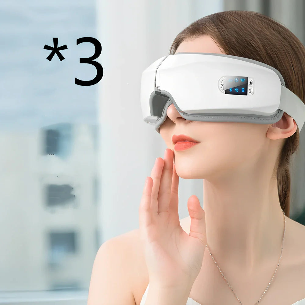 White folding eye massager device with LCD screen, shown in open and closed positions