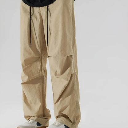 Men's loose straight-leg casual pants in thin ice silk fabric shown in black colour