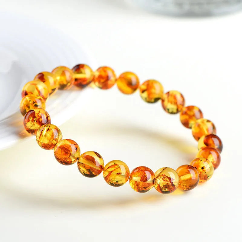 Natural yellow piebald amber bracelet with 7-10mm geometric beads on wrist