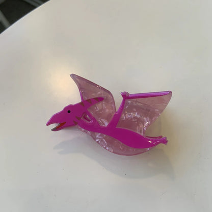 Acrylic dinosaur jaw clip hairpin showing six colour variations: pink, green, purple, blue, brown