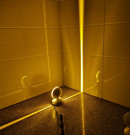 Aluminium and glass LED wall spotlight bar with colour change options, mounted on a corridor wall.