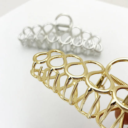 Large gold and silver minimalist hair clip with tassel detail for women's thick hair and updos.