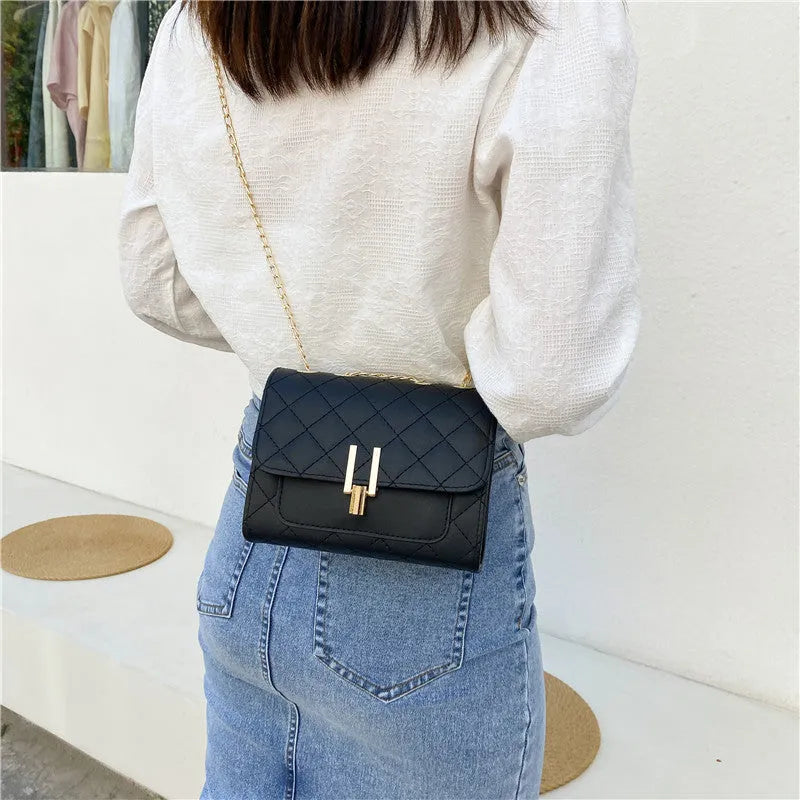 Women's solid colour PU leather crossbody bag with diamond lattice chain strap in black, green, or white.