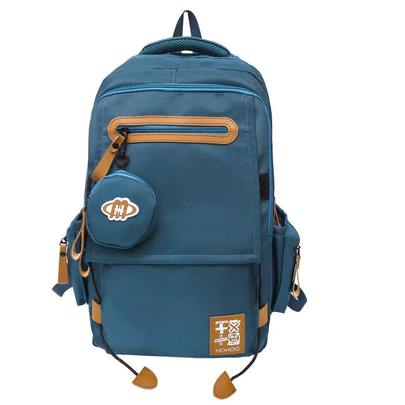 Large waterproof nylon travel backpack in blue with contrast stitching and 20-35 litre capacity