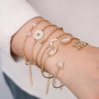 Set of six gold-colour zinc alloy bracelets with water drop, arrow, and V-shaped charms.