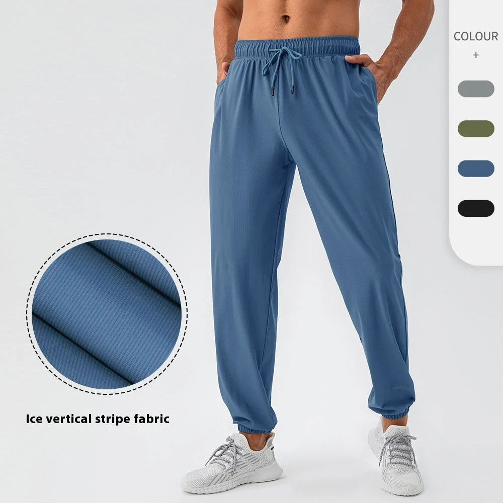 Men's lightweight nylon track pants in various colors, featuring a relaxed, flexible fit for active lifestyles