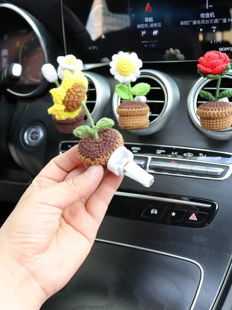 Creative wool potted plant car air vent clip aromatherapy pendant on a car vent.