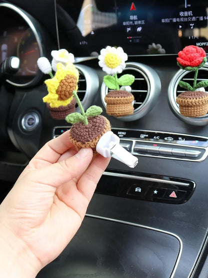 Creative wool potted plant car air vent clip aromatherapy pendant on a car vent.