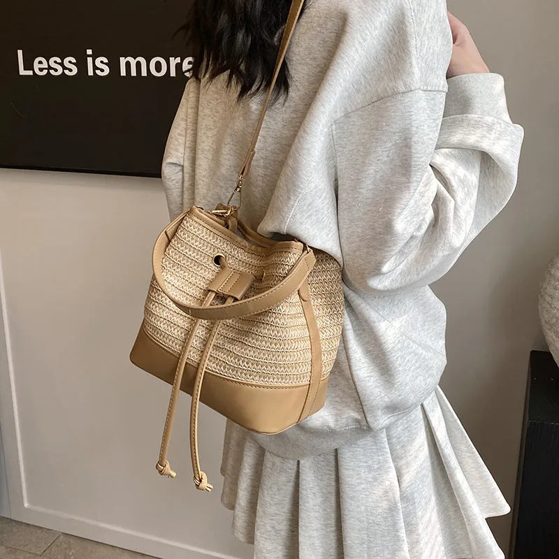 Woven straw women's crossbody bucket bag in brown colour with adjustable strap