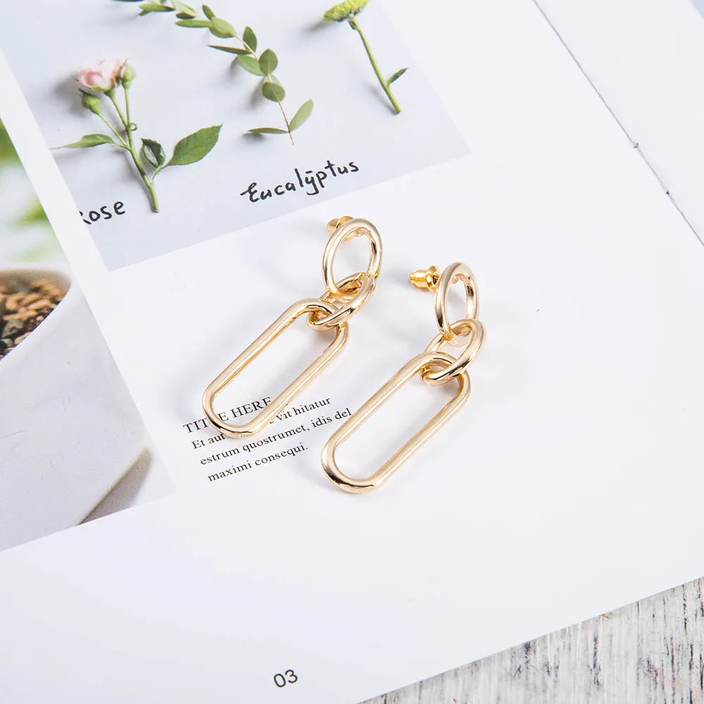 Geometric sterling silver needle finish hoop earrings showing ring and line design elements