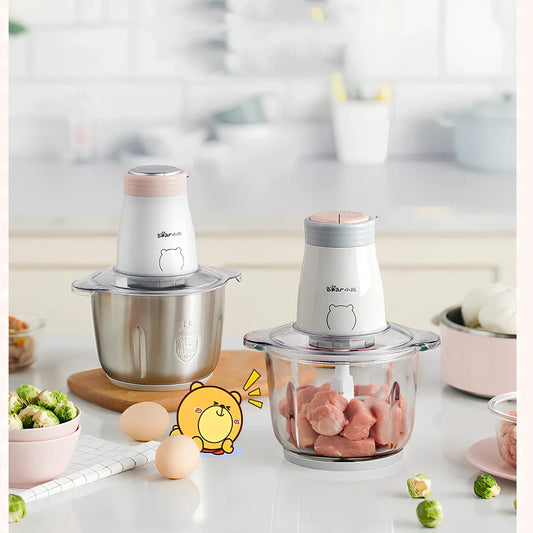 Household electric vegetable chopper blender with glass bowl and stainless steel blade on kitchen counter