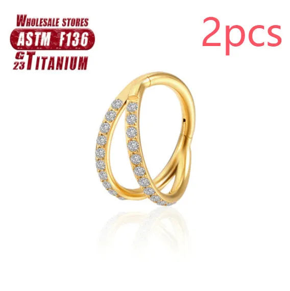 Pair of titanium alloy nose rings on a plain background showing silver, gold, black, and rose gold colour options.