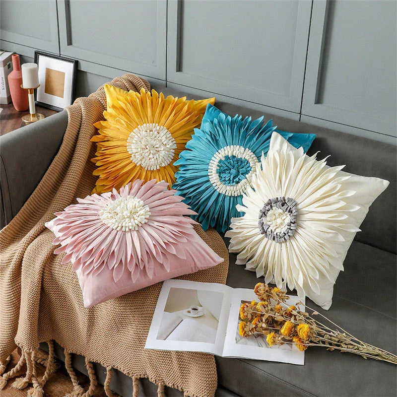 Stylish velvet throw pillows with 3D chrysanthemum embellishments in blue, yellow, pink, and white colors