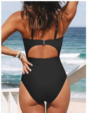 Black one-piece swimsuit on a model showing backless design