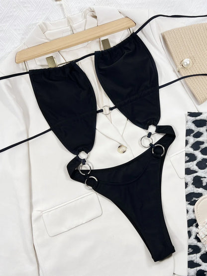 Black sleeveless one-piece swimsuit for women on a mannequin, showing steel ring detail and solid colour design.