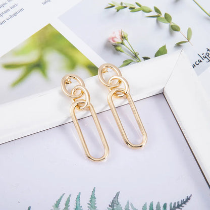 Geometric sterling silver needle finish hoop earrings showing ring and line design elements