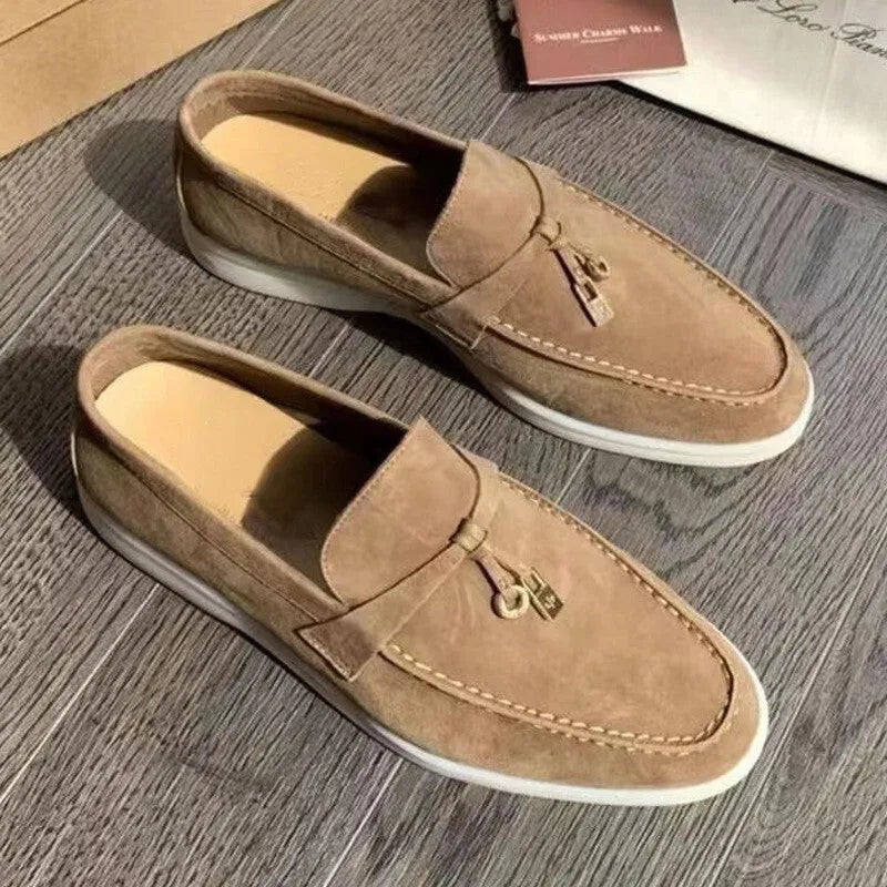 High top slip-on loafers in black with round toe and sewing line detail on a rubber sole.