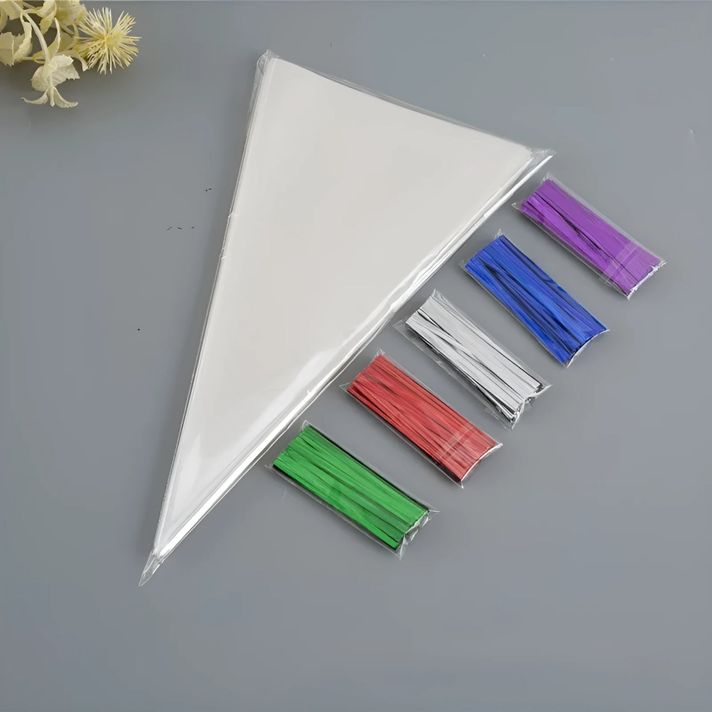 Transparent triangle plastic packaging bag with a twisted wire tie closure.