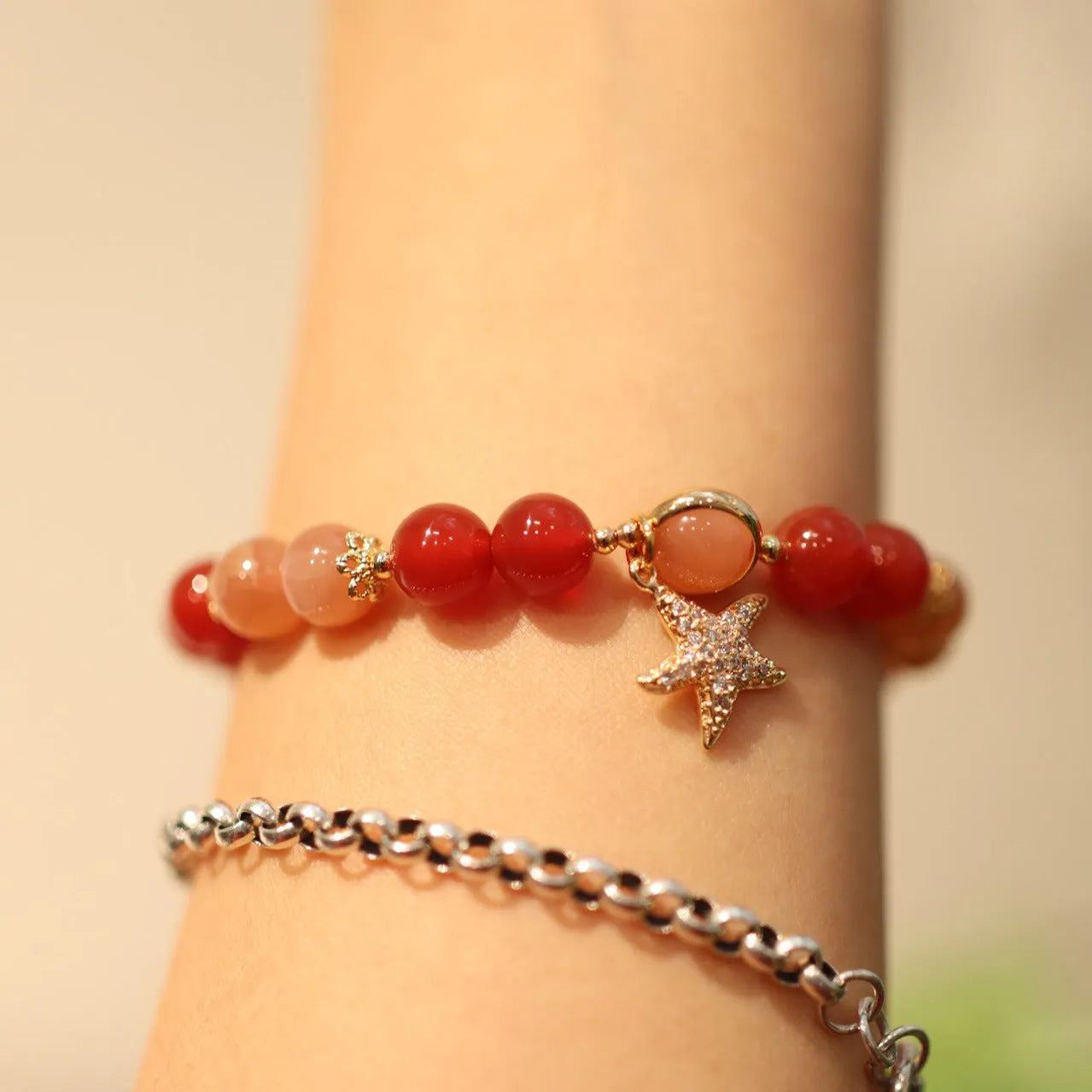 Women's handmade red agate and sunstone bracelet with ethnic charms