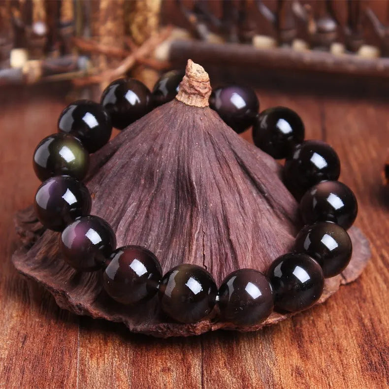 Natural Icy Obsidian crystal Pi Xiu bracelet with polished beads in ethnic geometric style.