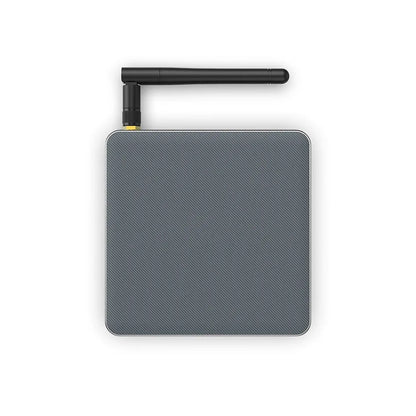Android TV set-top box with remote control showing HDMI and power ports